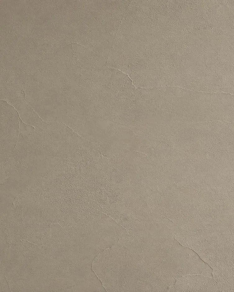 Close-up of greige microcement with a fine grain and soft trowel marks