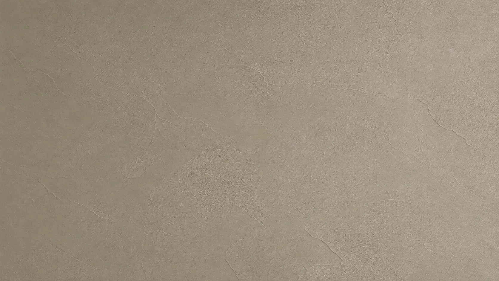 Close-up of greige microcement with a fine grain and soft trowel marks