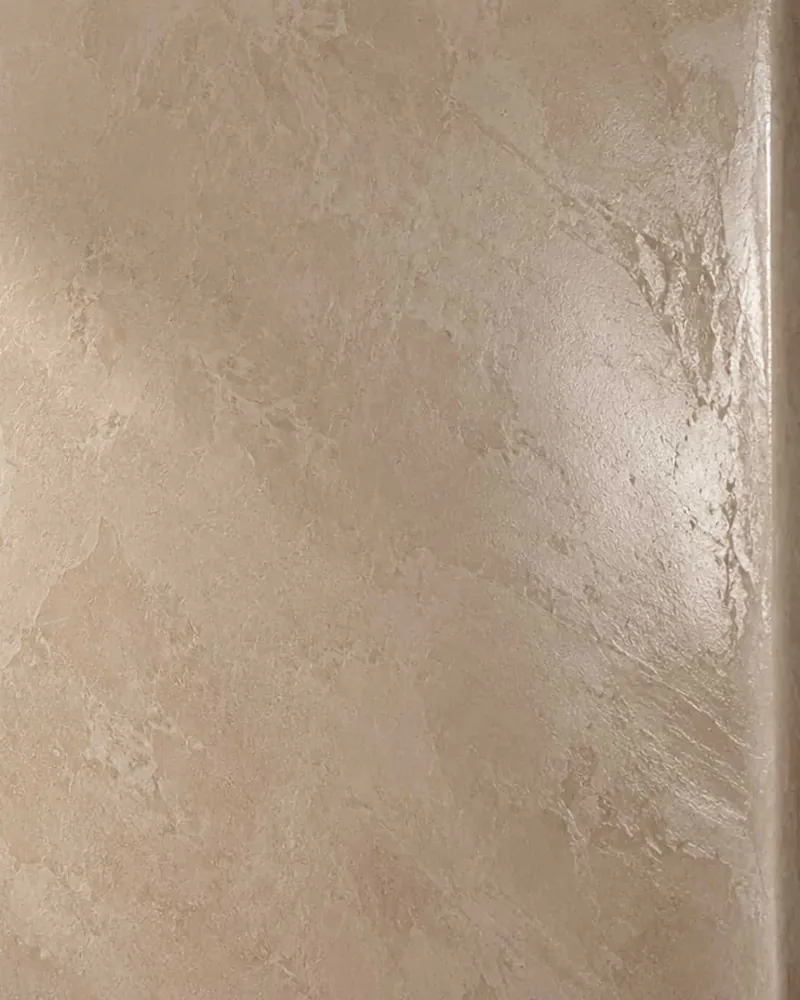 Polished Venetian plaster in warm ivory catching raking sunlight at an outside corner